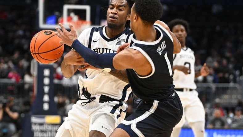 Jan 1, 2023; Washington, District of Columbia, USA; Butler Bulldogs guard Jayden Taylor (13) is fouled by Georgetown Hoyas guard Primo Spears (1) during the second half at Capital One Arena. Mandatory Credit: Brad Mills-USA TODAY Sports