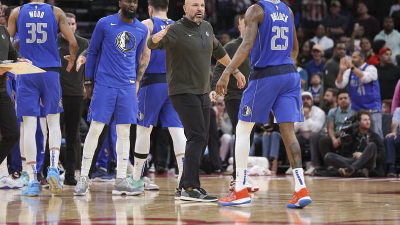 Jan 2, 2023; Houston, Texas, USA; Dallas Mavericks head coach Jason Kidd celebrates with forward Reggie Bullock (25) after a play during the fourth quarter against the Houston Rockets at Toyota Center. Mandatory Credit: Troy Taormina-USA TODAY Sports