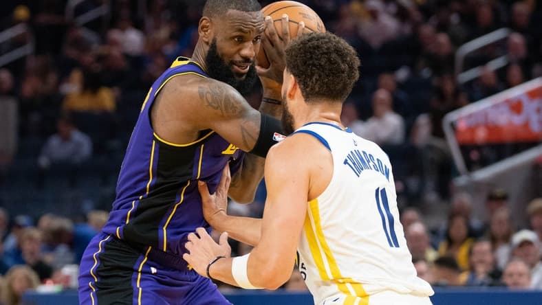 October 18, 2022; San Francisco, California, USA; Los Angeles Lakers forward LeBron James (6) controls the basketball against Golden State Warriors guard Klay Thompson (11) during the third quarter at Chase Center. Mandatory Credit: Kyle Terada-USA TODAY Sports