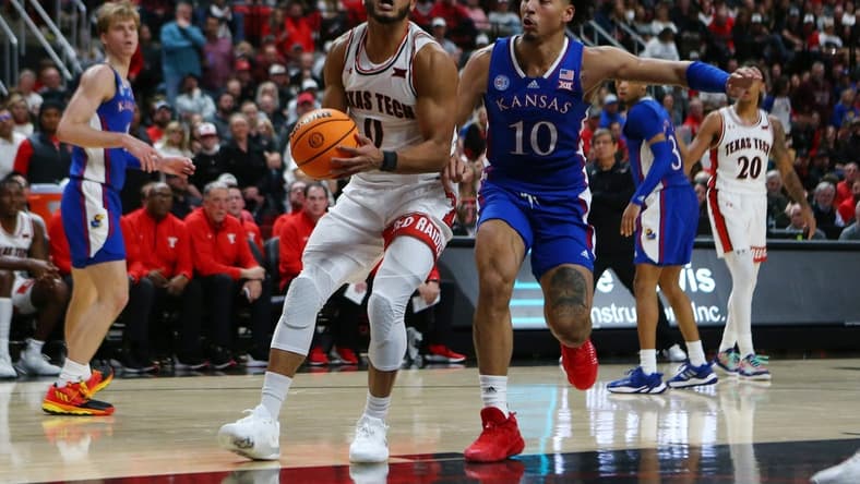 Jan 3, 2023; Lubbock, Texas, USA; Texas Tech Red Raiders forward Kevin Obanor (0) stops to shoot against Kansas Jayhawks forward Jalen Wilson (10) in the second half at United Supermarkets Arena. Mandatory Credit: Michael C. Johnson-USA TODAY Sports
