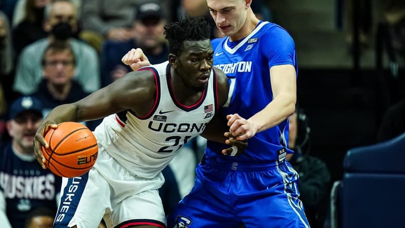 Jan 7, 2023; Storrs, Connecticut, USA; UConn Huskies forward Adama Sanogo (21) moves the ball against Creighton Bluejays center Ryan Kalkbrenner (11) in the second half at Harry A. Gampel Pavilion. Mandatory Credit: David Butler II-USA TODAY Sports