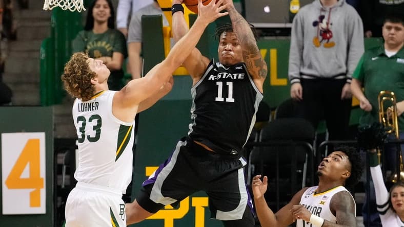 Jan 7, 2023; Waco, Texas, USA; Kansas State Wildcats forward Keyontae Johnson (11) grabs a rebound against Baylor Bears forward Caleb Lohner (33) during the first half at Ferrell Center. Mandatory Credit: Chris Jones-USA TODAY Sports
