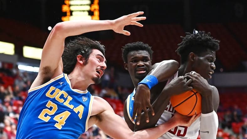 Dec 31, 2022; Spokane, Washington, USA; UCLA Bruins guard Jaime Jaquez Jr. (24) fights for the ball against Washington State Cougars forward Mouhamed Gueye (35) in the second half at McCarthey Athletic Center. Mandatory Credit: James Snook-USA TODAY Sports