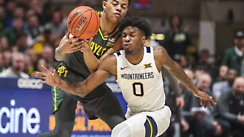 Jan 11, 2023; Morgantown, West Virginia, USA; West Virginia Mountaineers guard Kedrian Johnson (0) collides with Baylor Bears guard Keyonte George (1) while chasing the ball during the second half at WVU Coliseum. Mandatory Credit: Ben Queen-USA TODAY Sports