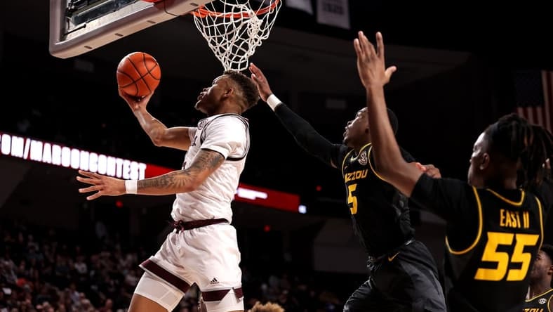 Jan 11, 2023; College Station, Texas, USA; Texas A&M Aggies guard Dexter Dennis (0) makes a reverse layup while Missouri Tigers guard D'Moi Hodge (5) defends during the second half at Reed Arena. Mandatory Credit: Erik Williams-USA TODAY Sports