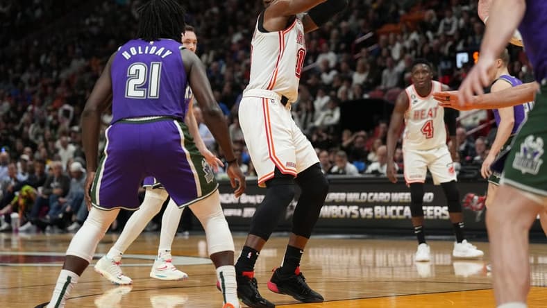 Jan 14, 2023; Miami, Florida, USA; Miami Heat center Bam Adebayo (13) shoots the ball against Milwaukee Bucks guard Jrue Holiday (21) during the second half at Miami-Dade Arena. Mandatory Credit: Jim Rassol-USA TODAY Sports