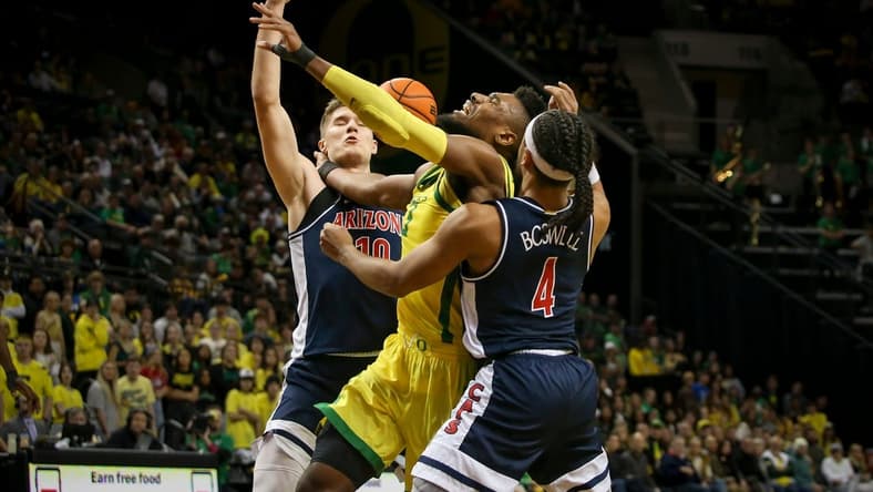 Oregon forward Quincy Guerrier is fouled by Arizona guard Kylan Boswell as the Oregon Ducks host the Arizona Wildcats Saturday, Jan. 14, 2023, at Matthew Knight Arena in Eugene, Ore.

Ncaa Basketball Arizona At Oregon Men S Basketball