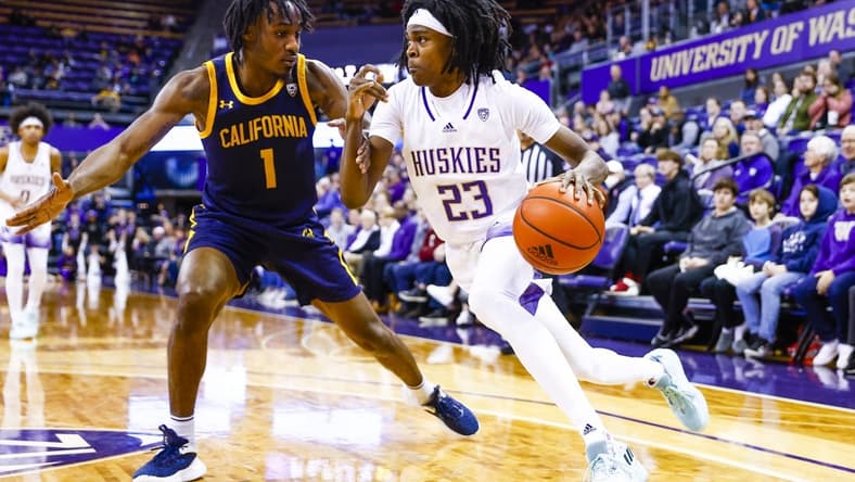 Jan 14, 2023; Seattle, Washington, USA; Washington Huskies guard Keyon Menifield (23) dribbles against California Golden Bears guard Joel Brown (1) during the second half at Alaska Airlines Arena at Hec Edmundson Pavilion. Mandatory Credit: Joe Nicholson-USA TODAY Sports