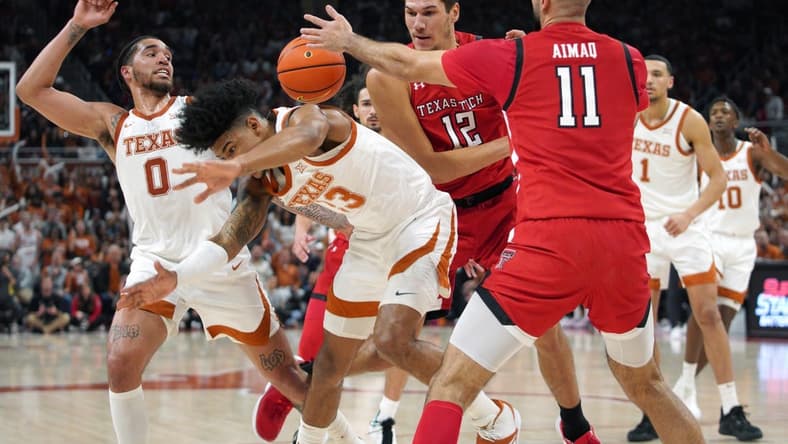 Jan 14, 2023; Austin, Texas, USA; Texas Longhorns forward Dillon Mitchell (23) forward Timmy Allen (0), Texas Tech Red Raiders forward Fardaws Aimaq (11), and forward Daniel Batcho (12) fight for control of the ball during the first half in a 72-70 Longhorns win at Moody Center. Mandatory Credit: Dustin Safranek-USA TODAY Sports