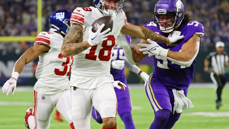 Jan 15, 2023; Minneapolis, Minnesota, USA; New York Giants wide receiver Isaiah Hodgins (18) runs with the ball against Minnesota Vikings linebacker Eric Kendricks (54) during the third quarter of a wild card game at U.S. Bank Stadium. Mandatory Credit: Matt Krohn-USA TODAY Sports