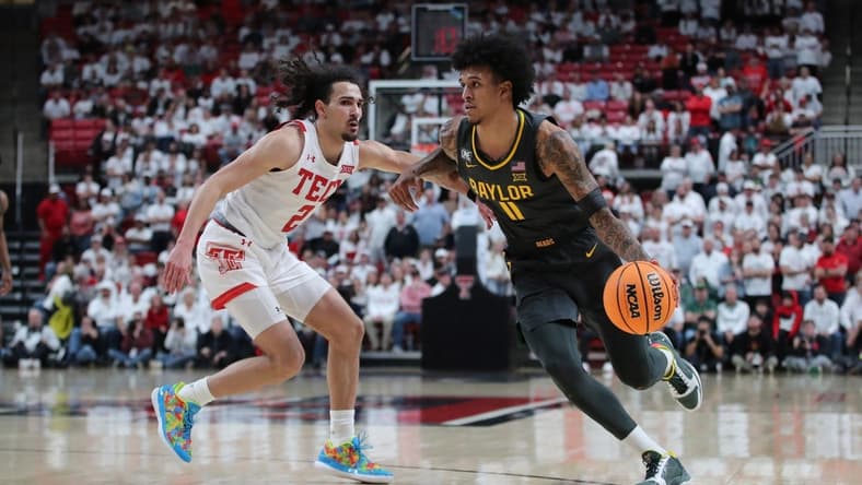 Jan 17, 2023; Lubbock, Texas, USA;  Baylor Bears forward Jalen Bridges (11) works the ball against Texas Tech Red Raiders guard Pop Isaacs (2) in the second half at United Supermarkets Arena. Mandatory Credit: Michael C. Johnson-USA TODAY Sports