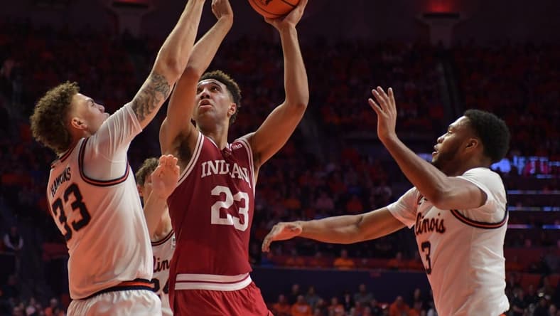 Jan 19, 2023; Champaign, Illinois, USA; Indiana Hoosiers forward Trayce Jackson-Davis (23) drives to the basket between Illinois Fighting Illini forward Coleman Hawkins (33) and Jayden Epps (3) during the second half at State Farm Center. Mandatory Credit: Ron Johnson-USA TODAY Sports