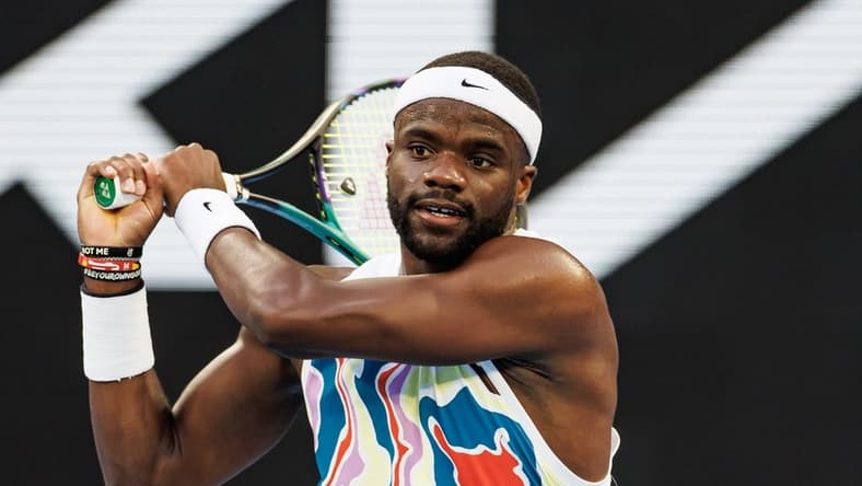 Jan 20, 2023; Melbourne, Victoria, Australia;  Frances Tiafoe of the United States hits a shot against Karen Kachanov of Russia on day five of the 2023 Australian Open tennis tournament at Melbourne Park. Mandatory Credit: Mike Frey-USA TODAY Sports