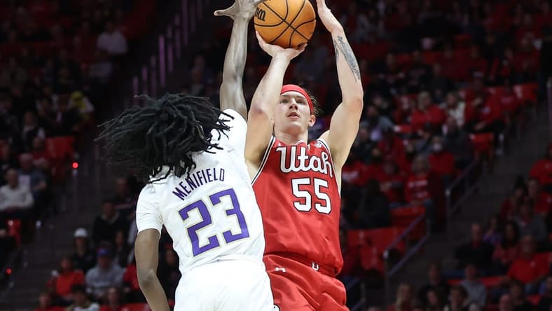 Jan 21, 2023; Salt Lake City, Utah, USA; Utah Utes guard Gabe Madsen (55) shoots against Washington Huskies guard Keyon Menifield (23) in the second half at Jon M. Huntsman Center. Mandatory Credit: Rob Gray-USA TODAY Sports