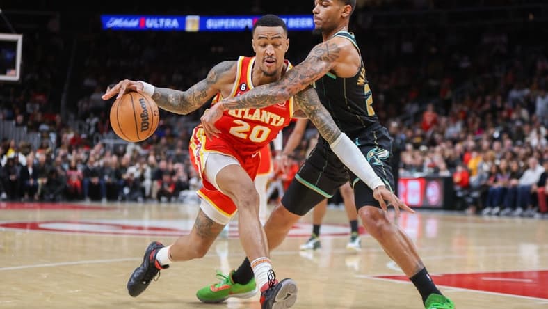 Jan 21, 2023; Atlanta, Georgia, USA; Atlanta Hawks forward John Collins (20) is defended by Charlotte Hornets forward P.J. Washington (25) in the second half at State Farm Arena. Mandatory Credit: Brett Davis-USA TODAY Sports