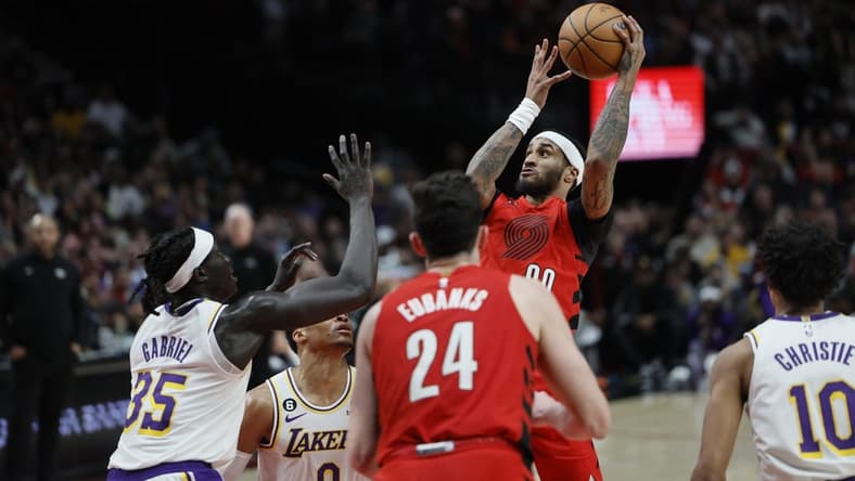 Jan 22, 2023; Portland, Oregon, USA; Portland Trail Blazers shooting guard Gary Payton II (00) shoots the ball over Los Angeles Lakers point guard Russell Westbrook (0) and forward Wenyen Gabriel (35) during the second half at Moda Center. Mandatory Credit: Soobum Im-USA TODAY Sports