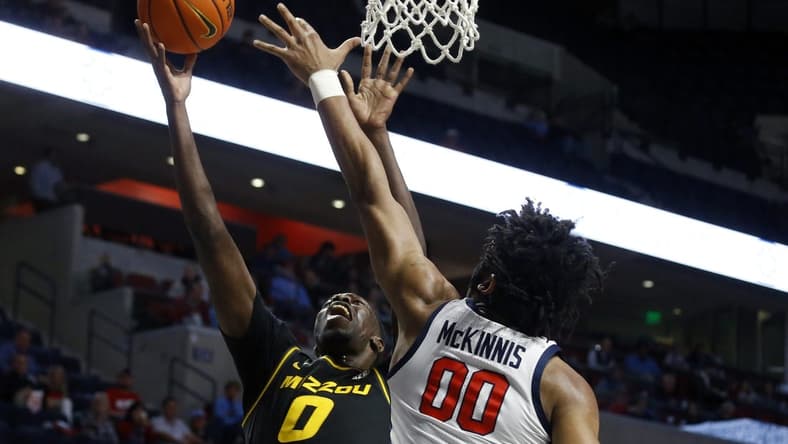 Jan 24, 2023; Oxford, Mississippi, USA; Missouri Tigers forward Mohamed Diarra (0) shoots as Mississippi Rebels forward Jayveous McKinnis (0) defends during the first half at The Sandy and John Black Pavilion at Ole Miss. Mandatory Credit: Petre Thomas-USA TODAY Sports