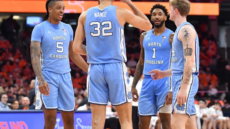 Jan 24, 2023; Syracuse, New York, USA; North Carolina Tar Heels players Armando Bacot (5) and Pete Nance (32) and Leaky Black (1) and Tyler Nickel (24) have a discussion during a timeout in the second half game against the Syracuse Orange at JMA Wireless Dome. Mandatory Credit: Mark Konezny-USA TODAY Sports