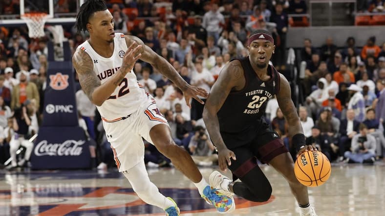 Jan 25, 2023; Auburn, Alabama, USA; Texas A&M Aggies guard Tyrece Radford (23) drives past Auburn Tigers guard Allen Flanigan (22) during the first half at Neville Arena. Mandatory Credit: John Reed-USA TODAY Sports