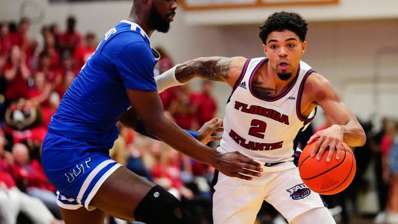 Jan 26, 2023; Boca Raton, Florida, USA; Florida Atlantic Owls guard Nicholas Boyd (2) dribbles past Middle Tennessee Blue Raiders guard Camryn Weston (24) during the second half at Eleanor R. Baldwin Arena. Mandatory Credit: Rich Storry-USA TODAY Sports