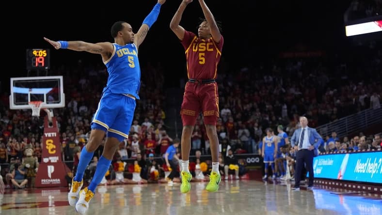 Jan 26, 2023; Los Angeles, California, USA; Southern California Trojans guard Boogie Ellis (right) shoots the ball against UCLA Bruins guard Amari Bailey in the second half at Galen Center. Mandatory Credit: Kirby Lee-USA TODAY Sports