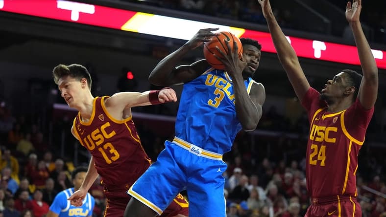 Jan 26, 2023; Los Angeles, California, USA; UCLA Bruins forward Adem Bona (3) battles for the ball with Southern California Trojans guard Drew Peterson (13) and forward Joshua Morgan (24) at Galen Center. Mandatory Credit: Kirby Lee-USA TODAY Sports