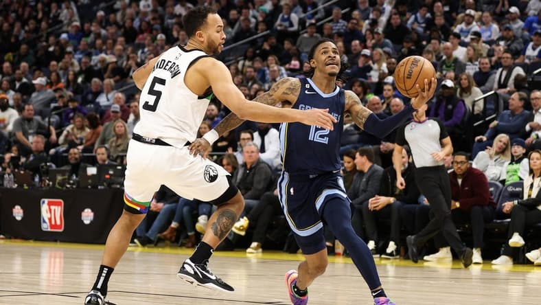 Jan 27, 2023; Minneapolis, Minnesota, USA; Memphis Grizzlies guard Ja Morant (12) drives to the basket while Minnesota Timberwolves forward Kyle Anderson (5) defends during the fourth quarter at Target Center. Mandatory Credit: Matt Krohn-USA TODAY Sports
