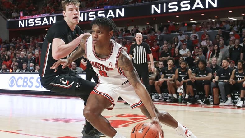 Jan 28, 2023; Houston, Texas, USA; Houston Cougars guard Marcus Sasser (0) dribbles against Cincinnati Bearcats forward Viktor Lakhin (30) in the second half at Fertitta Center. Houston Cougars won 75 to 69 .Mandatory Credit: Thomas Shea-USA TODAY Sports
