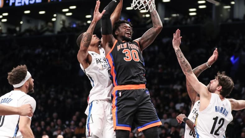 Jan 28, 2023; Brooklyn, New York, USA;  New York Knicks forward Julius Randle (30) drives past Brooklyn Nets center Nic Claxton (33) for a layup attempt in the second quarter at Barclays Center. Mandatory Credit: Wendell Cruz-USA TODAY Sports