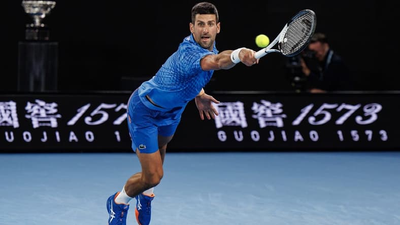 Jan 29, 2023; Melbourne, Victoria, Australia; Novak Djokovic of Serbia hits a shot against Stefanos Tsitsipas of Greece at the men's final on day fourteen of the 2023 Australian Open tennis tournament at Melbourne Park. Mandatory Credit: Mike Frey-USA TODAY Sports