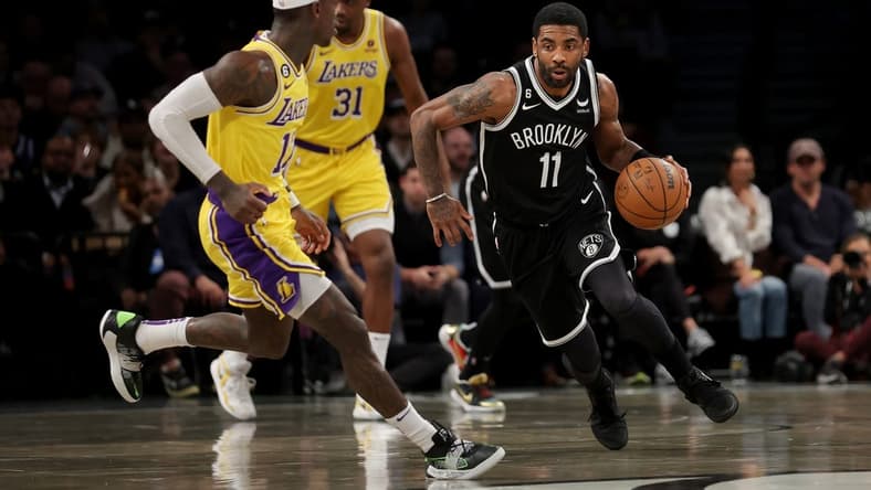 Jan 30, 2023; Brooklyn, New York, USA; Brooklyn Nets guard Kyrie Irving (11) brings the ball up court against Los Angeles Lakers guard Dennis Schroder (17) during the first quarter at Barclays Center. Mandatory Credit: Brad Penner-USA TODAY Sports