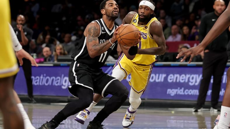 Jan 30, 2023; Brooklyn, New York, USA; Brooklyn Nets guard Kyrie Irving (11) takes a shot against Los Angeles Lakers guard Patrick Beverley (21) during the first quarter at Barclays Center. Mandatory Credit: Brad Penner-USA TODAY Sports
