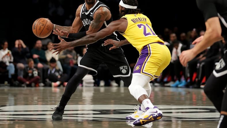 Jan 30, 2023; Brooklyn, New York, USA; Brooklyn Nets guard Kyrie Irving (11) passes the ball against Los Angeles Lakers guard Patrick Beverley (21) during the first quarter at Barclays Center. Mandatory Credit: Brad Penner-USA TODAY Sports