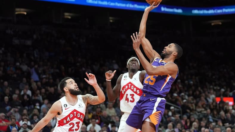 Jan 30, 2023; Phoenix, Arizona, USA; Phoenix Suns forward Mikal Bridges (25) shoots over Toronto Raptors guard Fred VanVleet (23) and Toronto Raptors forward Pascal Siakam (43) during the first half at Footprint Center. Mandatory Credit: Joe Camporeale-USA TODAY Sports