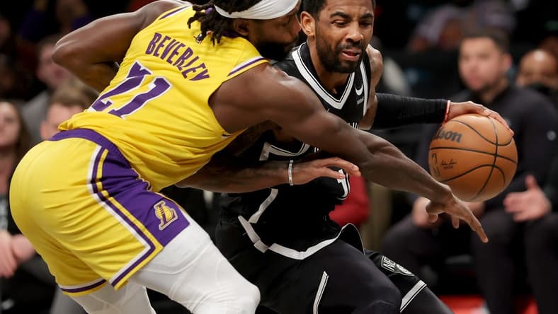 Jan 30, 2023; Brooklyn, New York, USA; Brooklyn Nets guard Kyrie Irving (11) is fouled as he brings the ball up court by Los Angeles Lakers guard Patrick Beverley (21) during the second quarter at Barclays Center. Mandatory Credit: Brad Penner-USA TODAY Sports