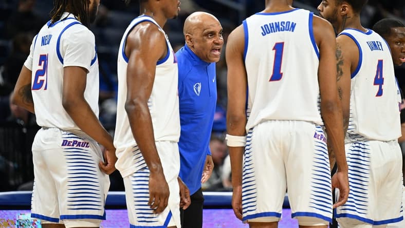 Jan 31, 2023; Chicago, Illinois, USA; DePaul Blue Demons head coach Tony Stubblefield (center) talks to forward Da'Sean Nelson (21), forward Eral Penn (11), forward Javan Johnson (1) and guard K.T. Raimey (4) during a timeout in the first half against the Connecticut Huskies at Wintrust Arena. Mandatory Credit: Jamie Sabau-USA TODAY Sports