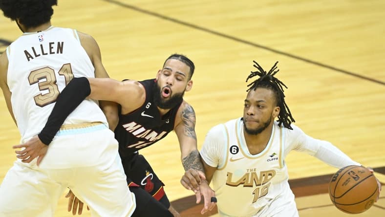 Jan 31, 2023; Cleveland, Ohio, USA; Miami Heat forward Caleb Martin (16) tries to get between Cleveland Cavaliers center Jarrett Allen (31) and guard Darius Garland (10) in the fourth quarter at Rocket Mortgage FieldHouse. Mandatory Credit: David Richard-USA TODAY Sports