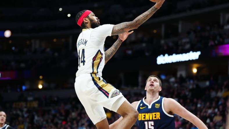 Jan 31, 2023; Denver, Colorado, USA; New Orleans Pelicans forward Brandon Ingram (14) shoots the ball in the first quarter against the Denver Nuggets at Ball Arena. Mandatory Credit: Ron Chenoy-USA TODAY Sports