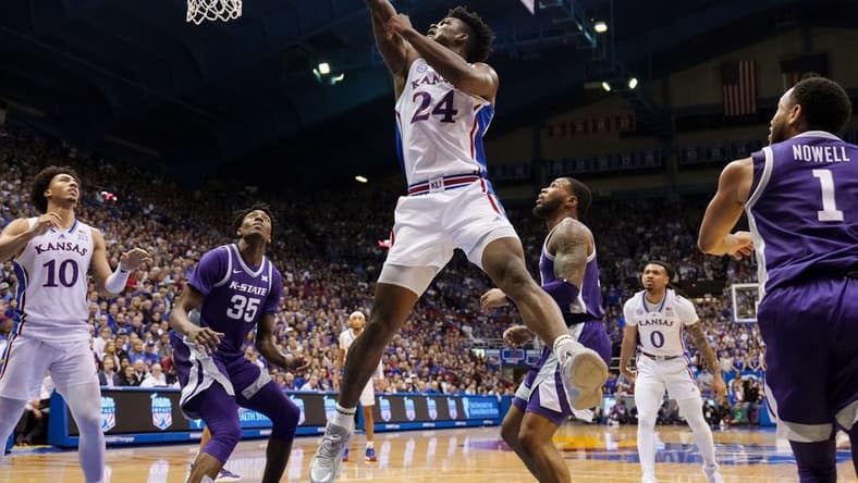 Jan 31, 2023; Lawrence, Kansas, USA; Kansas Jayhawks forward K.J. Adams Jr. (24) shoots against Kansas State Wildcats forward Nae'Qwan Tomlin (35) and guard Desi Sills (13) during the second half at Allen Fieldhouse. Mandatory Credit: Jay Biggerstaff-USA TODAY Sports