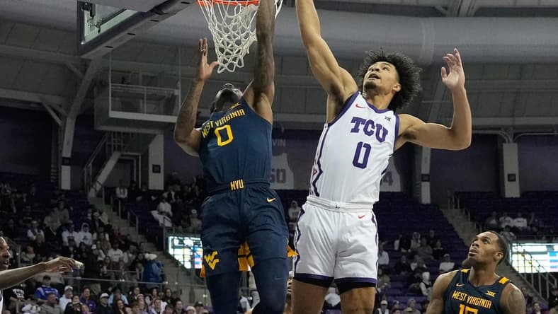 Jan 31, 2023; Fort Worth, Texas, USA; West Virginia Mountaineers guard Kedrian Johnson (0) has his shot blocked by TCU Horned Frogs guard Micah Peavy (0) during the second half at Ed and Rae Schollmaier Arena. Mandatory Credit: Chris Jones-USA TODAY Sports