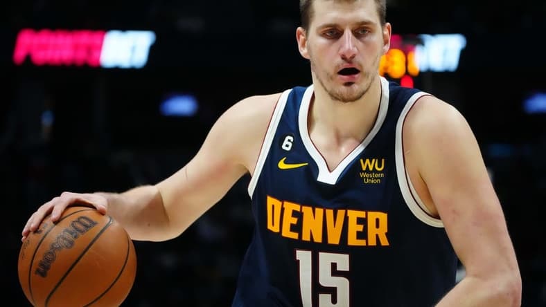 Jan 31, 2023; Denver, Colorado, USA; Denver Nuggets center Nikola Jokic (15) dribbles the ball in the second half against the New Orleans Pelicans at Ball Arena. Mandatory Credit: Ron Chenoy-USA TODAY Sports