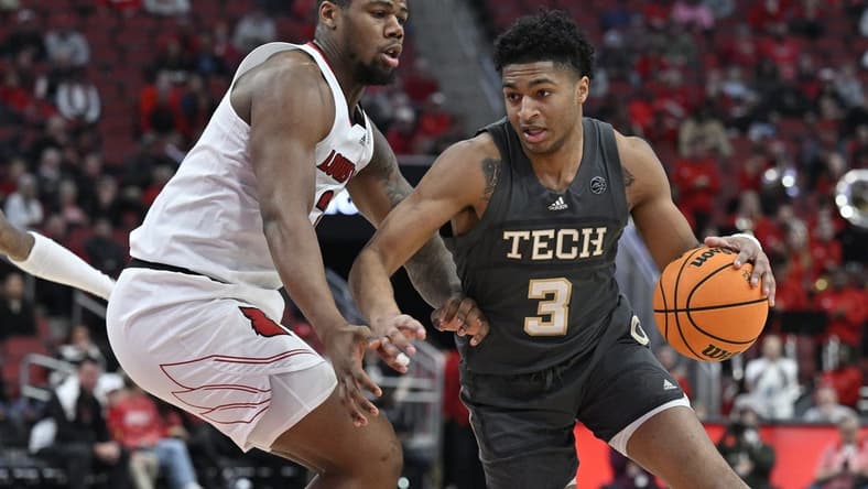 Feb 1, 2023; Louisville, Kentucky, USA;  Georgia Tech Yellow Jackets guard Dallan Coleman (3) dribbles against Louisville Cardinals forward Sydney Curry (21) during the first half at KFC Yum! Center. Mandatory Credit: Jamie Rhodes-USA TODAY Sports