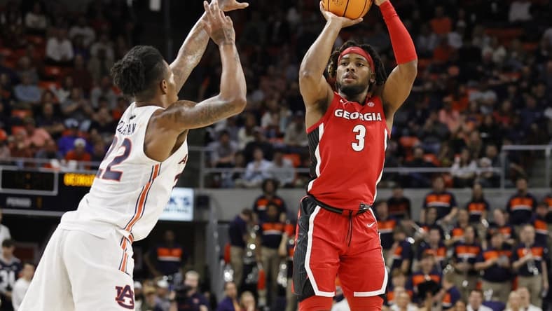 Feb 1, 2023; Auburn, Alabama, USA;  Georgia Bulldogs guard Kario Oquendo (3) goes over Auburn Tigers guard Allen Flanigan (22) for a shot during the first half at Neville Arena. Mandatory Credit: John Reed-USA TODAY Sports