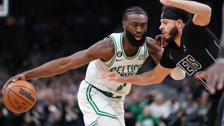 Feb 1, 2023; Boston, Massachusetts, USA; Boston Celtics guard Jaylen Brown (7) drives the ball against Brooklyn Nets guard Seth Curry (30) in the first quarter at TD Garden. Mandatory Credit: David Butler II-USA TODAY Sports