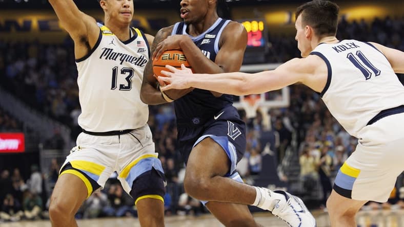 Feb 1, 2023; Milwaukee, Wisconsin, USA; Villanova Wildcats forward Brandon Slater (34) drives for the basket between Marquette Golden Eagles forward Oso Ighodaro (13) and guard Tyler Kolek (11) during the first half at Fiserv Forum. Mandatory Credit: Jeff Hanisch-USA TODAY Sports