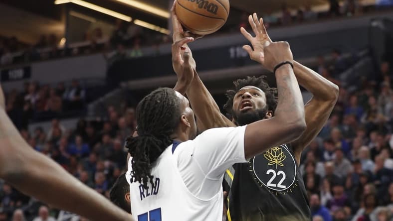 Feb 1, 2023; Minneapolis, Minnesota, USA; Golden State Warriors forward Andrew Wiggins (22) shoots against the Minnesota Gophers Minnesota Timberwolves center Naz Reid (11) in the first quarter at Target Center. Mandatory Credit: Bruce Kluckhohn-USA TODAY Sports