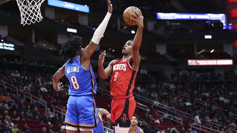 Feb 1, 2023; Houston, Texas, USA; Houston Rockets guard Josh Christopher (9) attempts to score a basket as Oklahoma City Thunder forward Jalen Williams (8) defends during the second quarter at Toyota Center. Mandatory Credit: Troy Taormina-USA TODAY Sports