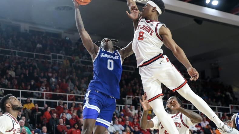 Feb 1, 2023; Queens, New York, USA; Seton Hall Pirates guard Kadary Richmond (0) looks to drive past St. John's Red Storm guard AJ Storr (2) in the first half at Carnesecca Arena. Mandatory Credit: Wendell Cruz-USA TODAY Sports