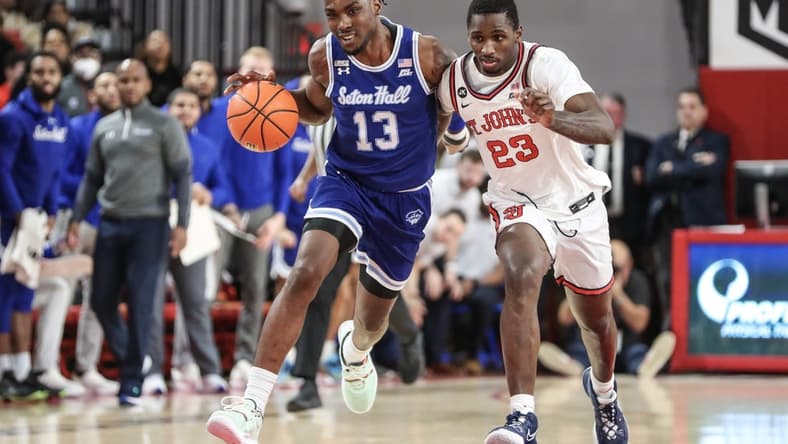 Feb 1, 2023; Queens, New York, USA; Seton Hall Pirates forward KC Ndefo (13) looks to drive past St. John's Red Storm forward David Jones (23) in the first half at Carnesecca Arena. Mandatory Credit: Wendell Cruz-USA TODAY Sports