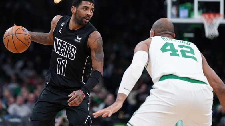Feb 1, 2023; Boston, Massachusetts, USA; Brooklyn Nets guard Kyrie Irving (11) returns the ball against Boston Celtics center Al Horford (42) in the second half at TD Garden. Mandatory Credit: David Butler II-USA TODAY Sports